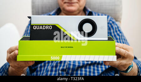 Paris, France - Mar 28 2019: Wide image of senior man showing demonstrating latest Nvidia Quadro RTX 5000 workstation GPU with powerful machine learning capabilities built by nvidia Stock Photo