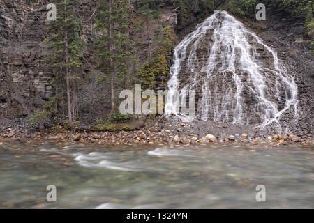 A waterfall tumbles into the river along the Maligne Canyon, Jasper, National Park, Canada, taken on a long exposure. Stock Photo