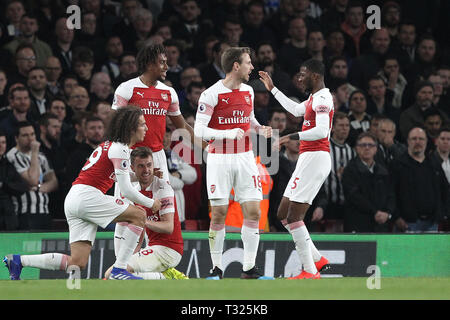 LONDON, ENGLAND 1st April (L-R) Matteo Guendouzi, Alex Iwobi, Nacho Monreal and Ainsley Maitland-Niles congratulate Aaron Ramsey (kneeling) after he scored Arsenal's their first goal during the Premier League match between Arsenal and Newcastle United at the Emirates Stadium, London on Monday 1st April 2019. (Credit: Mark Fletcher | MI News)  Editorial use only, license required for commercial use. No use in betting, games or a single club/league/player publications. Photograph may only be used for newspaper and/or magazine editorial purposes. May not be used for publications involving 1 playe Stock Photo