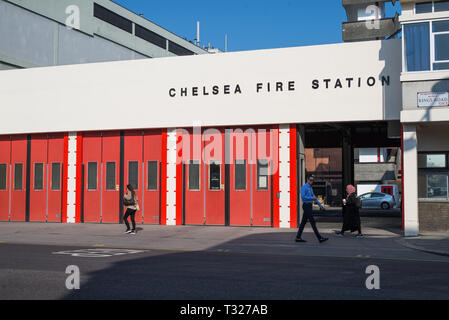 A man and two women walking past Chelsea fire station in King's Road, London, England, UK Stock Photo