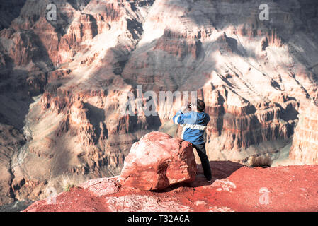 GRAND CANYON - February 19: Tourists take pictures at Eagle Point at Grand Canyon West Rim on February 19, 2017 in Grand Canyon, AZ Stock Photo