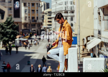 Young lawyer using his cellphone during walking in the city center Stock Photo