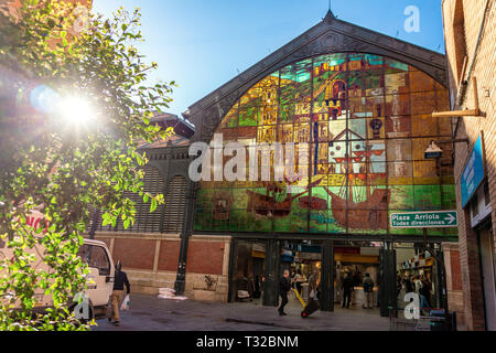 Malaga, Spain 04. 03. 2019: Outside of the Atarazanas market in Malaga Spain with decorated glass and people on the street on a sunny day flare Stock Photo