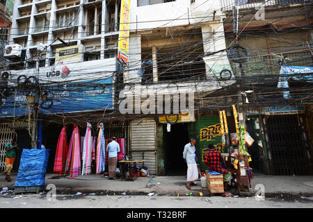Electric cables hanging over the sidewalks in Dhaka, Bangladesh. Stock Photo