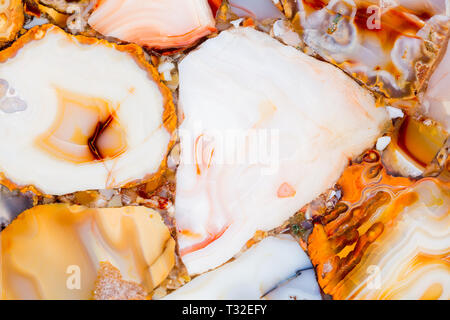 Relief agate texture with shiny light brown surface. Stock Photo