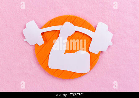 muscular built concept image. paper pink background Stock Photo