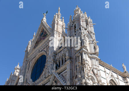 Siena, Italy - June 28, 2018: Panoramic facade of Siena Cathedral (Duomo di Siena) is a medieval church in Siena, dedicated from its earliest days as 