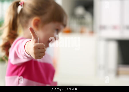 Little girl show approve or OK sign with her arm Stock Photo