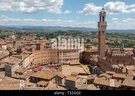 Panoramic view of Siena city with Piazza del Campo and the Torre del Mangia is a tower in city from Siena Cathedral (Duomo di Siena). Summer sunny day Stock Photo