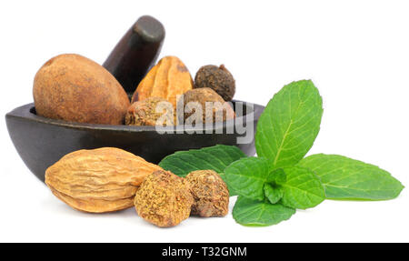 Triphala-a combination of ayurvedic fruits with mint leaves on white background Stock Photo