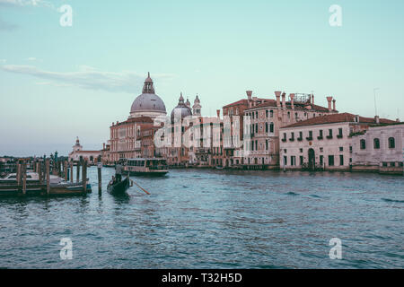 Venice, Italy - June 30, 2018: Panoramic view of Venice grand canal view with historical buildings, gondola and boats, away of Basilica Salute. Landsc Stock Photo