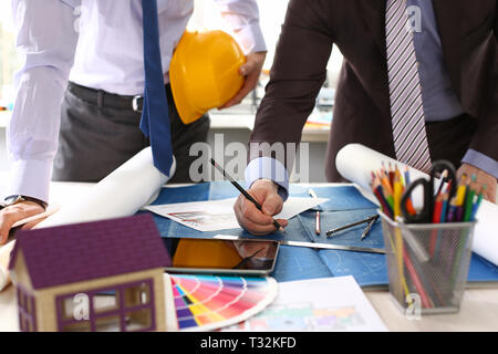 Two male workers examining blueprint papers Stock Photo