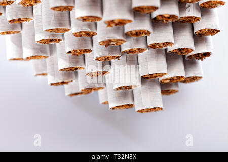 A pile of tobacco cigarettes stacked isolated on white. Stock Photo