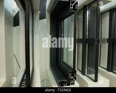 showcase of modern aluminum plastic windows frames in a row. cutted for better inside view Stock Photo