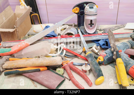 dirty construction tools randomly scattered on the desktop Stock Photo
