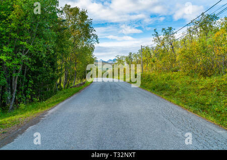 Empty road on Hakoya - a 3.69-square-kilometre island located between the islands Kvaloya and Tromsoya in Troms county, Norway Stock Photo