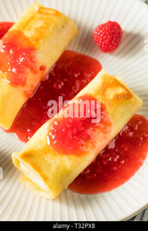 Sweet Homemade Cheese Blintzes with Raspberry Sauce Stock Photo