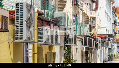 Rear of homes and many air conditioners in a laneway in Joo Chiat Singapore. Stock Photo