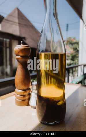 Cooking oil and pepper shaker on a table Stock Photo