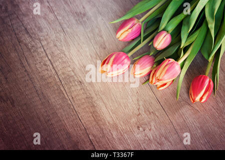 A bunch of tulips on wooden background Stock Photo