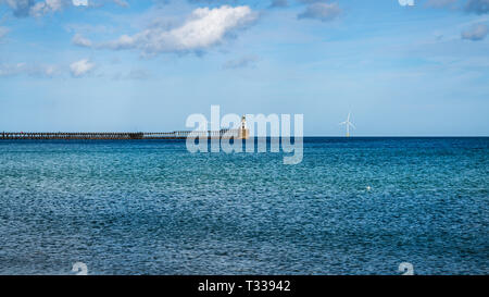 Blyth Lighthouse, the pier and a wind turbine on the North Sea Coast, seen on South Beach in Blyth, England, UK Stock Photo