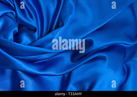 Blue silk canvas cloth waves background or texture Stock Photo
