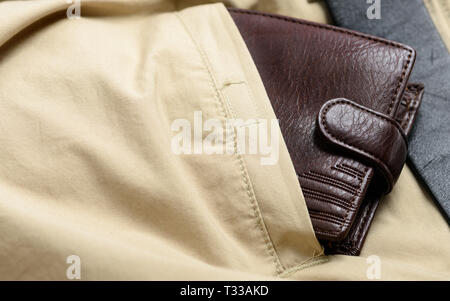 Brown leather wallet in the back pocket of casual pants Stock Photo