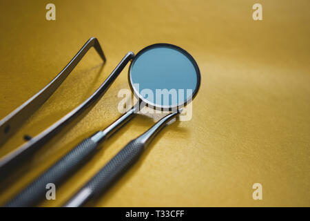 Close-up Dental Instruments on a yellow background. Prevention of oral diseases. Stock Photo