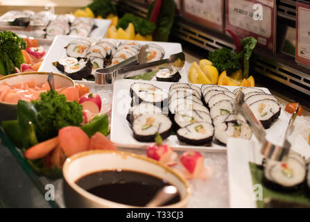Sushi slices placed next to soya sauces Stock Photo