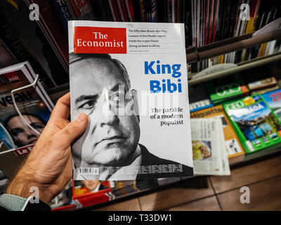 Paris, France - 29 Mar 2019: Man reading The Economist magazine with portrait of Benjamin Netanyahu and ironic title King Bibi a few days before the elections in Israel  Stock Photo