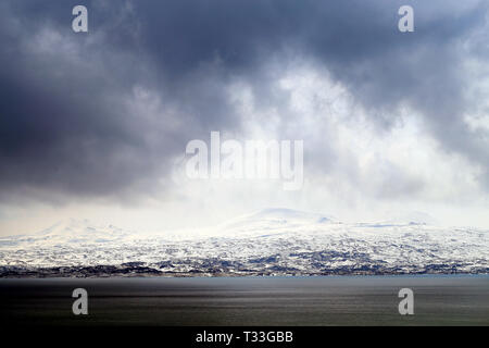 Photo background mountain landscape on a cloudy snowy day in Armenia on Sevan Stock Photo