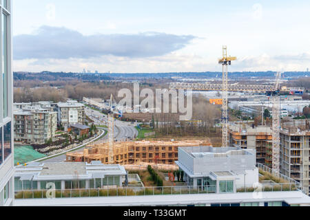 Aerial top view of the River District - apartment housing developments under construction in Vancouver, BC, on Marine Drive. Cranes in scene. Stock Photo