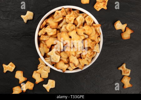 Goldfish crackers in a bowl, shot from above on a black background with copy space Stock Photo