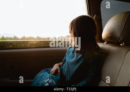 little girl enjoying the trip in back seat Stock Photo