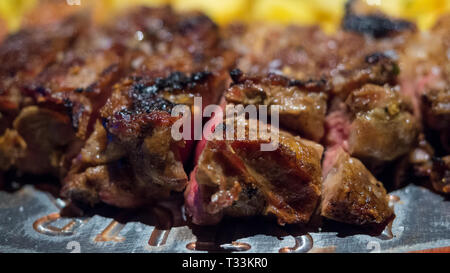 Close-up detail of a beef rib grilled with fried potatoes, Spanish food Stock Photo
