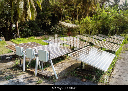 Guyed Cell Tower with solar panels installed on the ground. satellite dish, satellite antenna, satellite aerial, satellite receiver Stock Photo