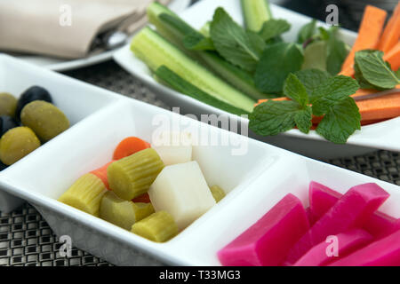 Fresh and pickled vegetables on a plates Stock Photo
