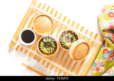 Asian Food concept homemade Dim Sum steamed garlic chives dumplings in Dim Sum Bamboo Steamer Basket on white background Stock Photo
