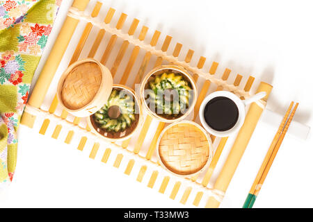 Asian Food concept homemade Dim Sum steamed garlic chives dumplings in Dim Sum Bamboo Steamer Basket on white background Stock Photo