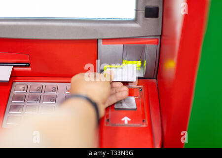 Hand of man using an ATM machine with credit card. Stock Photo