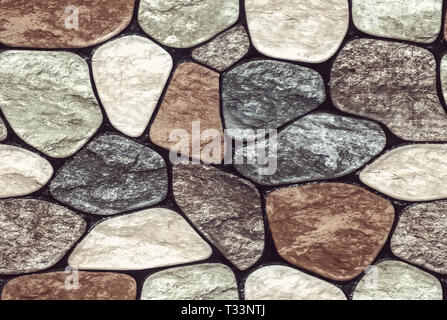 Wall round stone rock texture and seamless background. pale color of the stones. Marble texture. Stock Photo