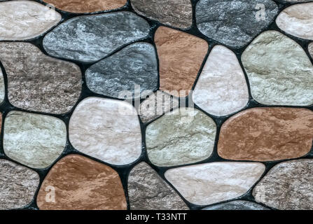 multicolored stone with rounded faces wall background. Seamless background Stock Photo