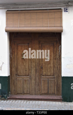 Antique wooden door with wooden handles and shutters from Alicante Stock Photo
