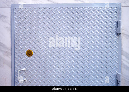 painted diamond streel door with bronz lock and handle Stock Photo