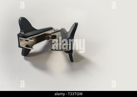 classic staple remover at a white desk office Stock Photo