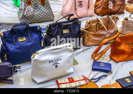 Fake world-famous brands, fake Prada handbags, Gucci bags Valencia Spain  street sale Stock Photo - Alamy