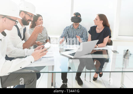 engineer in virtual reality glasses at a meeting with the business team Stock Photo