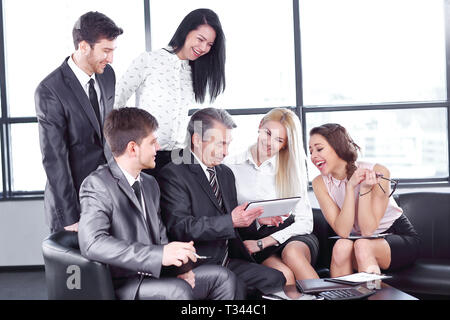 businessman uses a digital tablet at a working meeting with employees Stock Photo