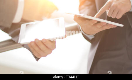close up. two businessmen with tablet computers Stock Photo