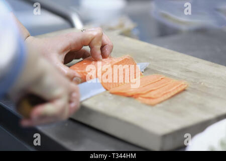 close up. chef slicing fish for sushi Stock Photo